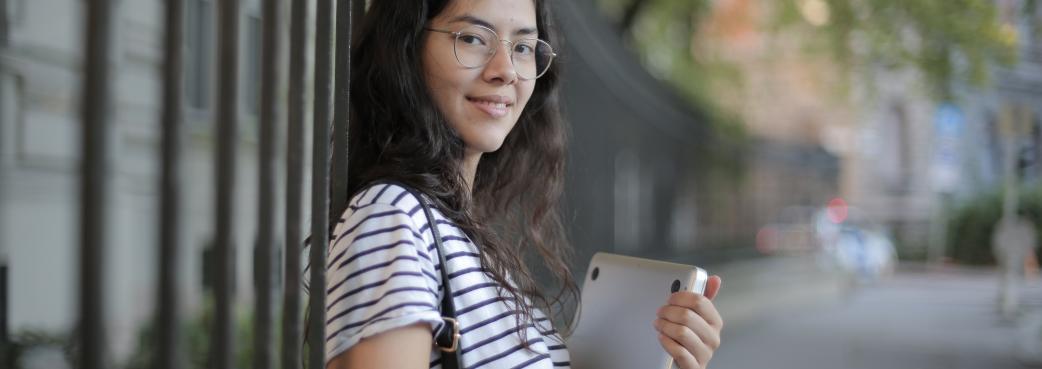 woman-in-black-and-white-striped-shirt-holding-laptop-3808811.jpg